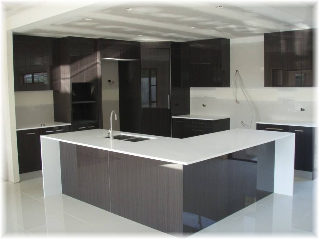 A Kitchen With Black Cabinets and White Counter Tops — Suncoast Kitchens In Caloundra, QLD