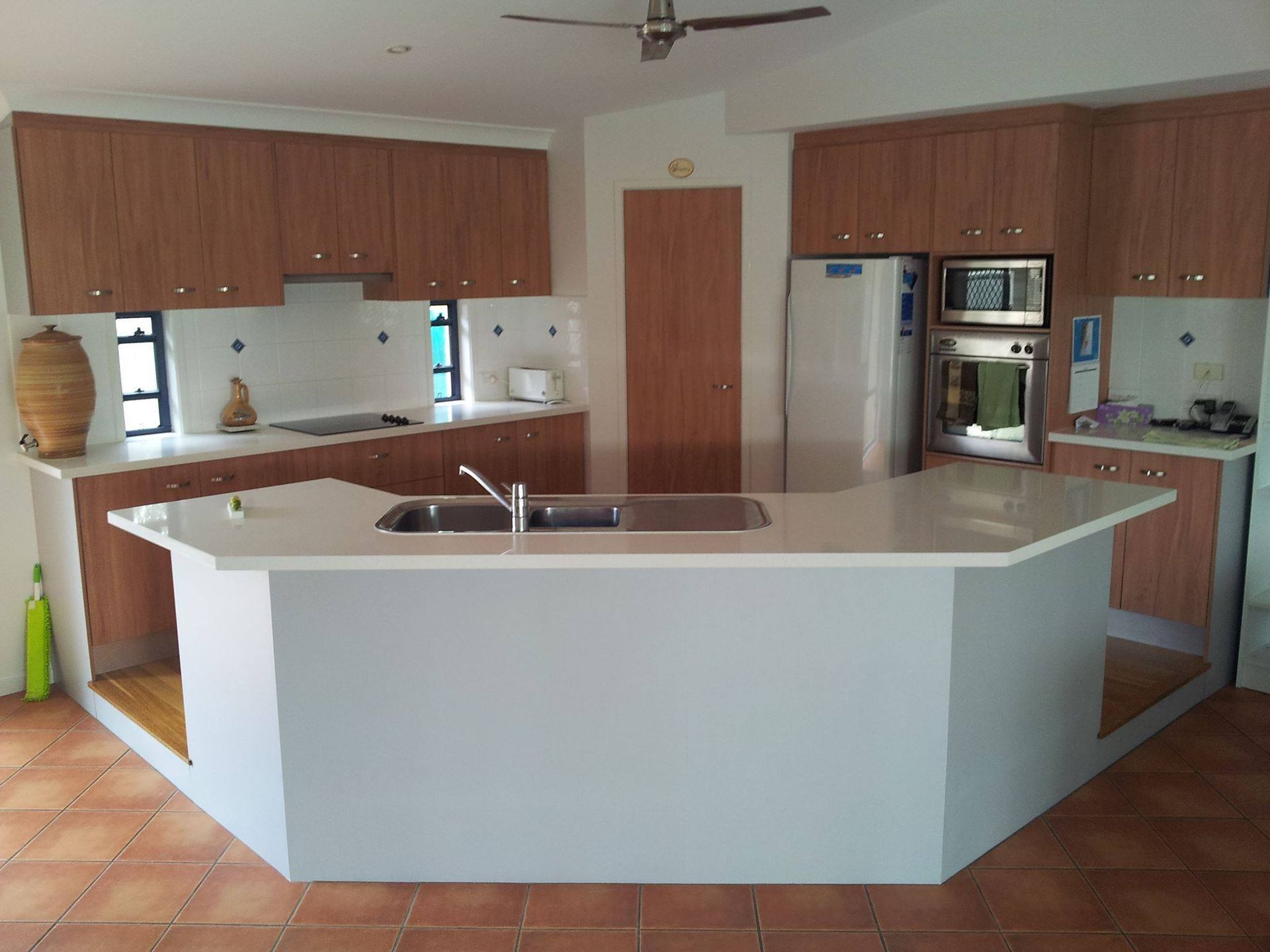 A Kitchen With Wooden Cabinets and White Counter Tops — Suncoast Kitchens In Gympie, QLD