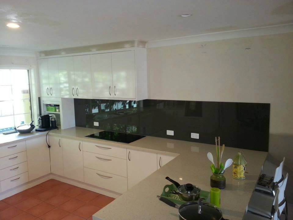 A Kitchen With White Cabinets and a Black Backsplash — Suncoast Kitchens In Caboolture, QLD