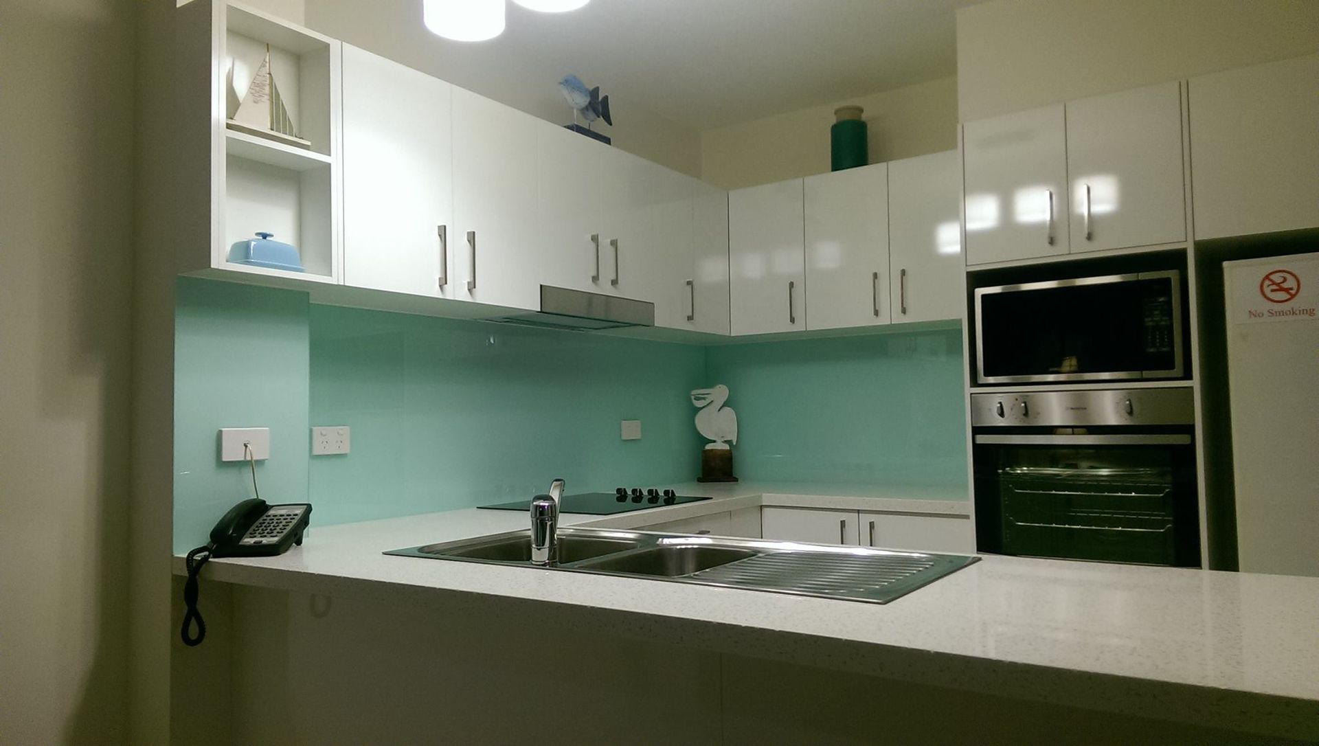 A Kitchen With White Cabinets and a Telephone on the Counter — Suncoast Kitchens In Caloundra, QLD