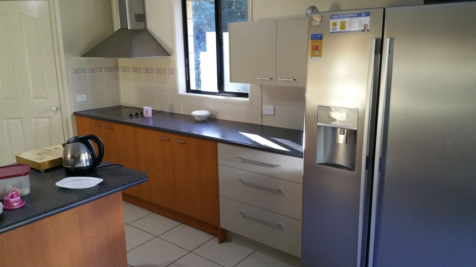 A Kitchen With Stainless Steel Appliances and Wooden Cabinets — Suncoast Kitchens In Kunda Park, QLD