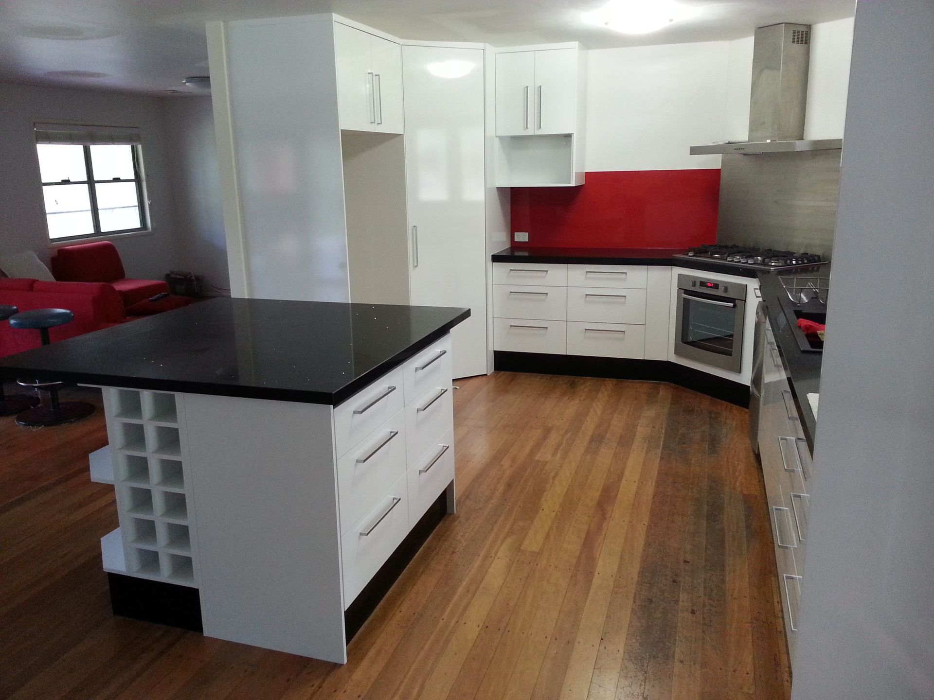 A Kitchen With White Cabinets and Black Counter Tops — Suncoast Kitchens In Noosa, QLD