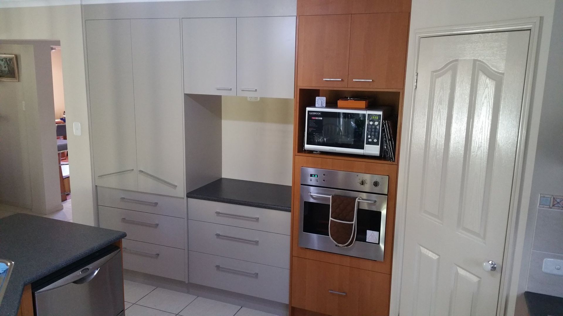 A Kitchen With Stainless Steel Appliances and Wooden Cabinets — Suncoast Kitchens In Kunda Park, QLD