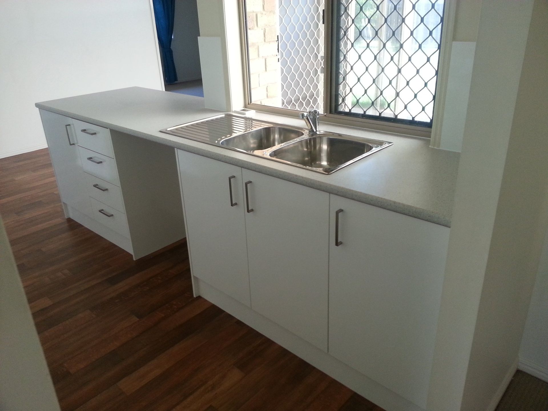 A Kitchen With White Cabinets and a Stainless Steel Sink — Suncoast Kitchens In Buderim, QLD