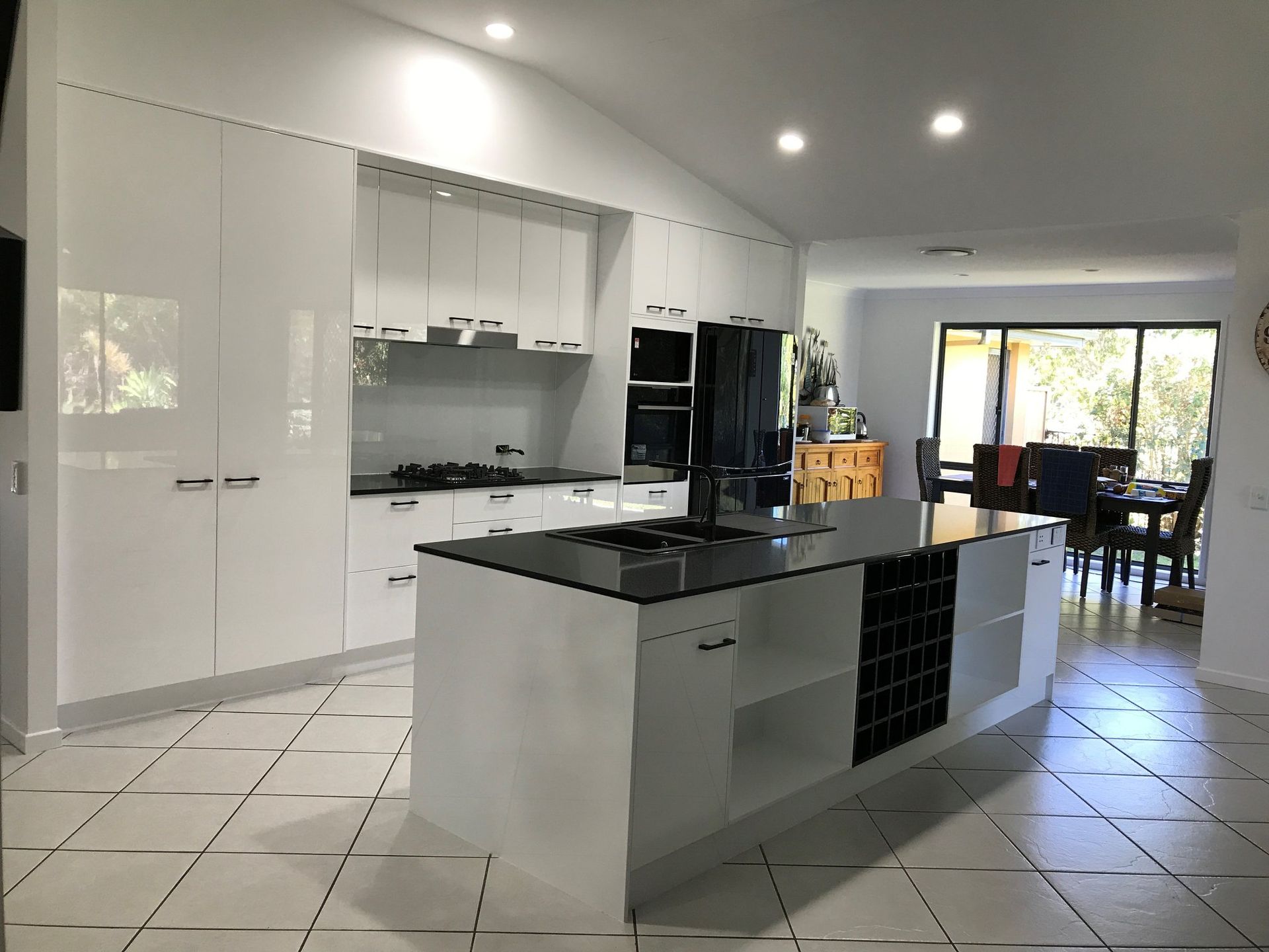 A Kitchen With White Cabinets and Black Counter Tops — Suncoast Kitchens In Noosa, QLD