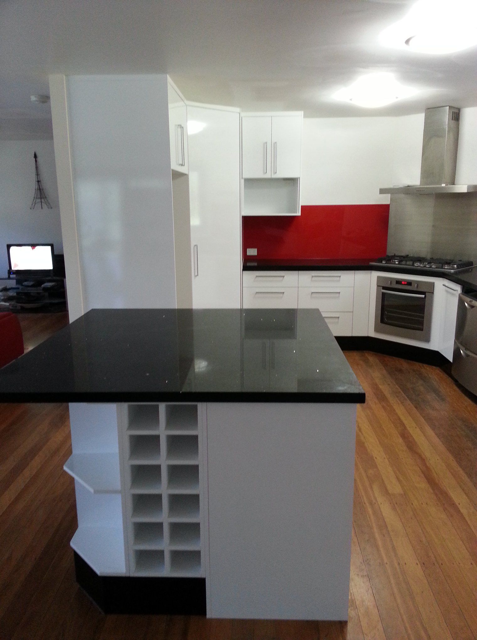 A Kitchen With a Black Counter Top and White Cabinets — Suncoast Kitchens In Noosa, QLD