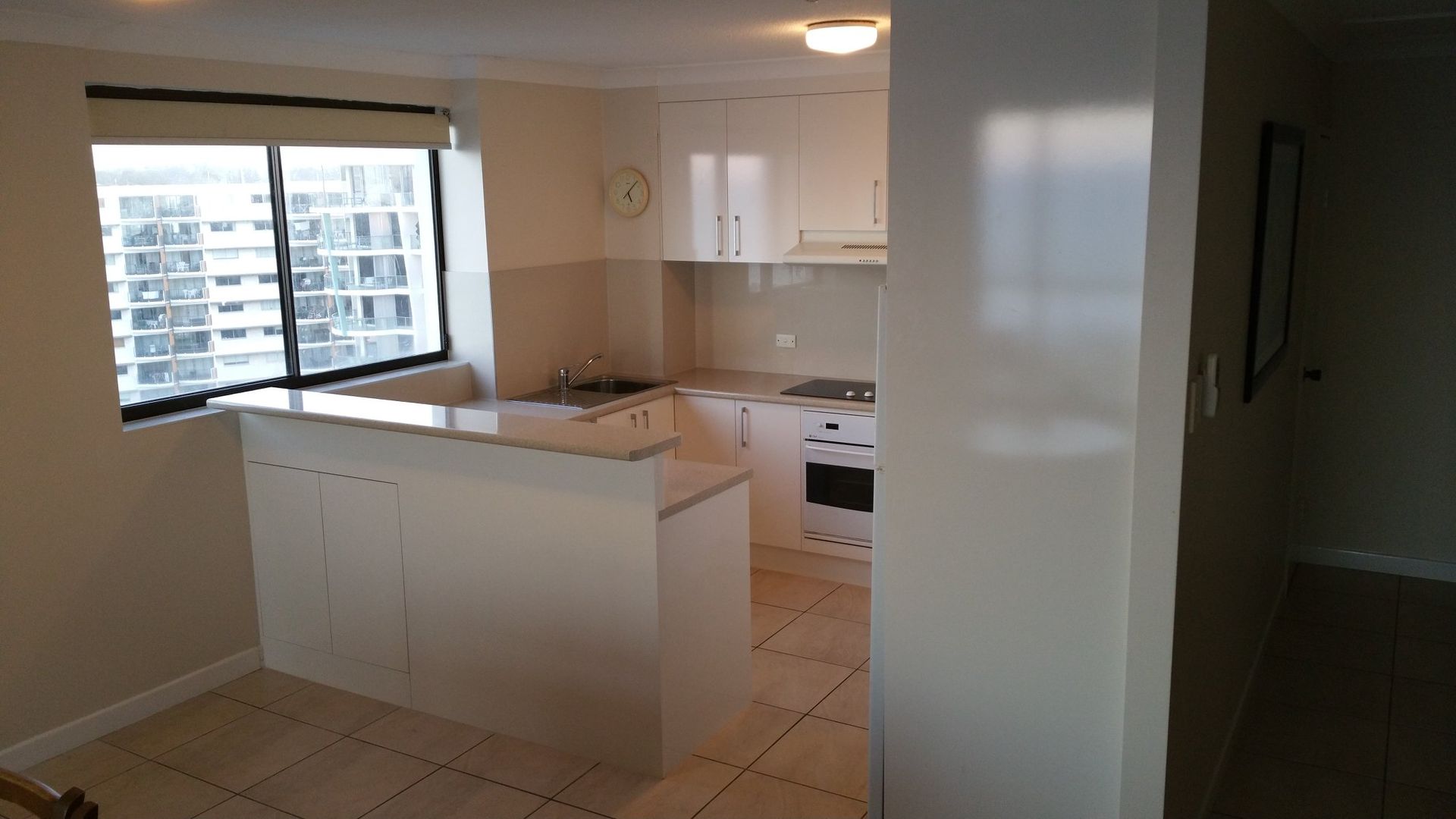 A Kitchen With White Cabinets and a Large Window — Suncoast Kitchens In Kunda Park, QLD