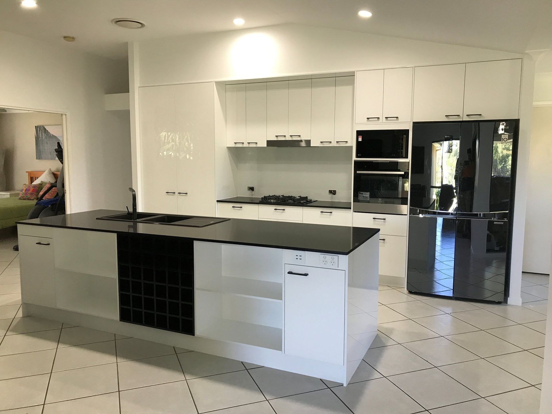A Kitchen With White Cabinets and a Black Refrigerator — Suncoast Kitchens In Caloundra, QLD