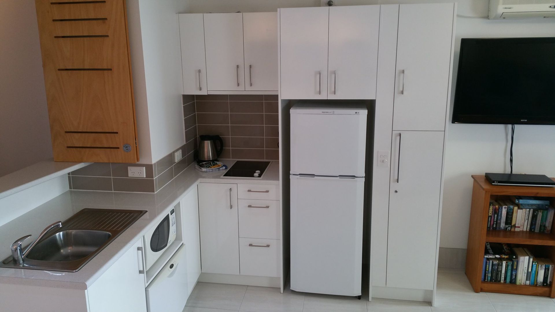 A Kitchen With White Cabinets and a Refrigerator — Suncoast Kitchens In Kunda Park, QLD