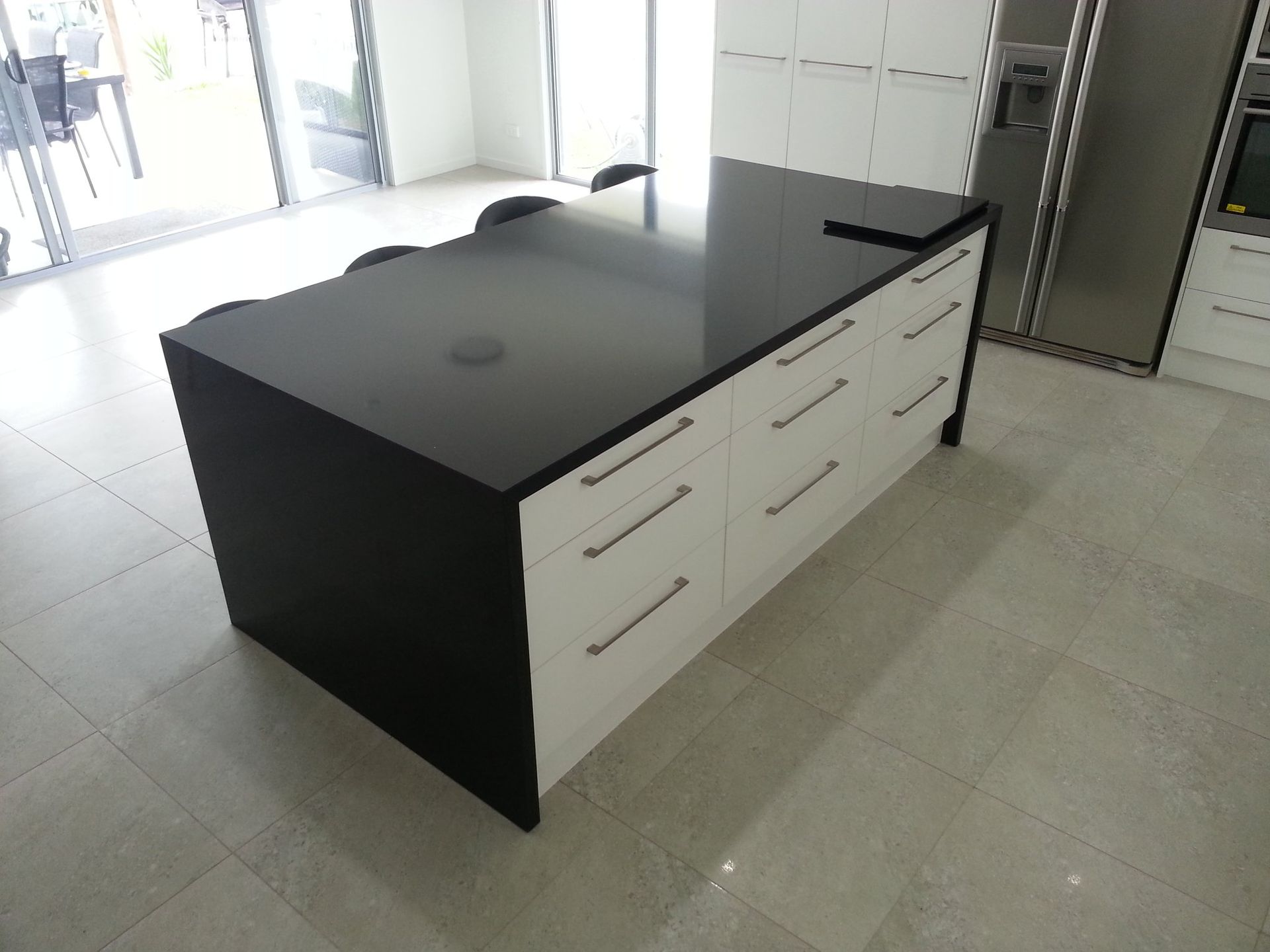 A Kitchen With a Black Counter Top and White Drawers — Suncoast Kitchens In Maroochydore, QLD