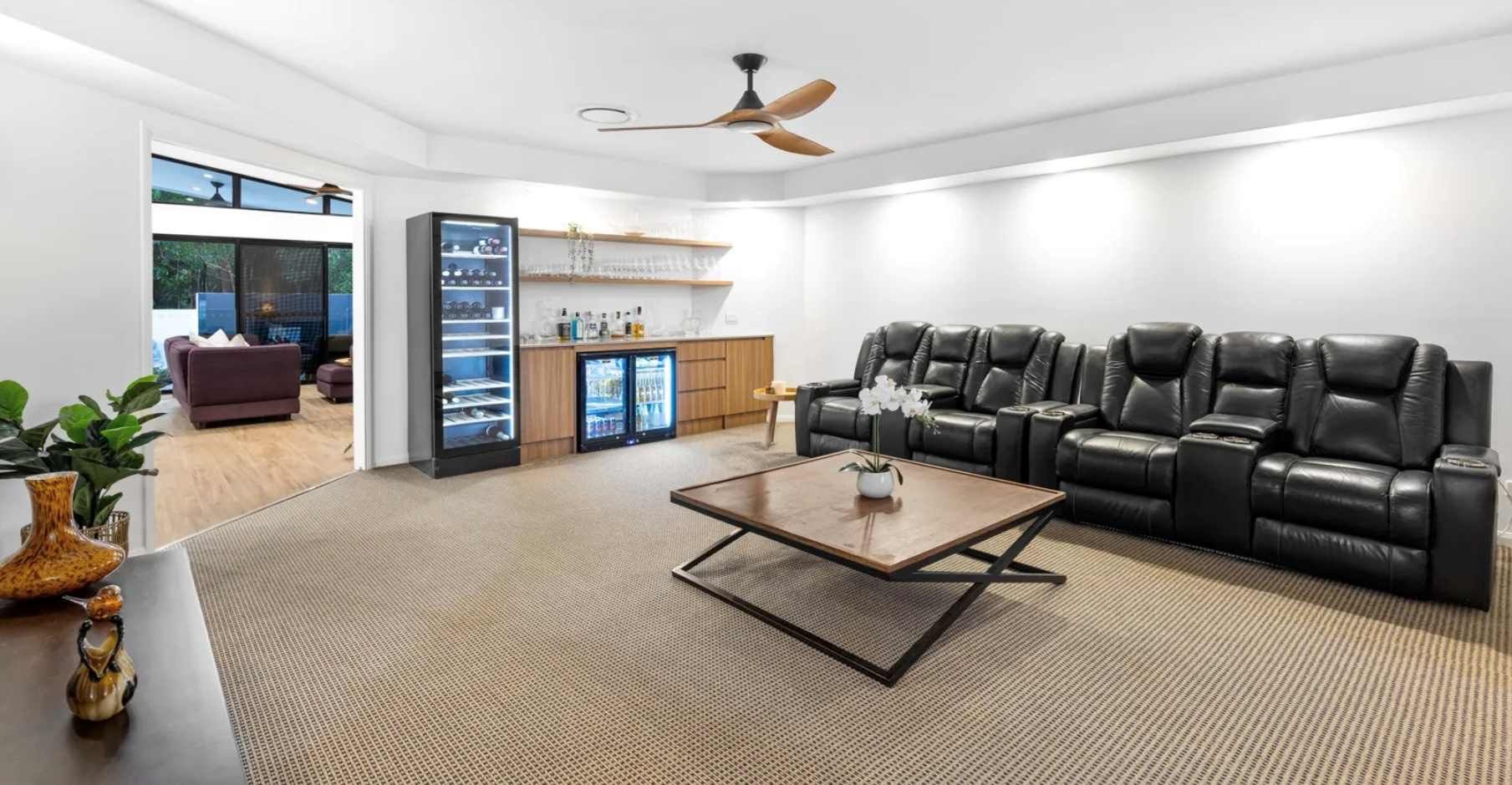 A Living Room With a Lot of Furniture and a Ceiling Fan — Suncoast Kitchens In Kunda Park, QLD