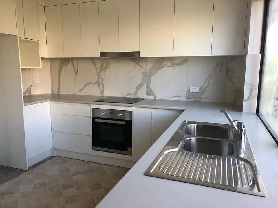 A Kitchen With White Cabinets and a Stainless Steel Sink — Suncoast Kitchens In Kunda Park, QLD