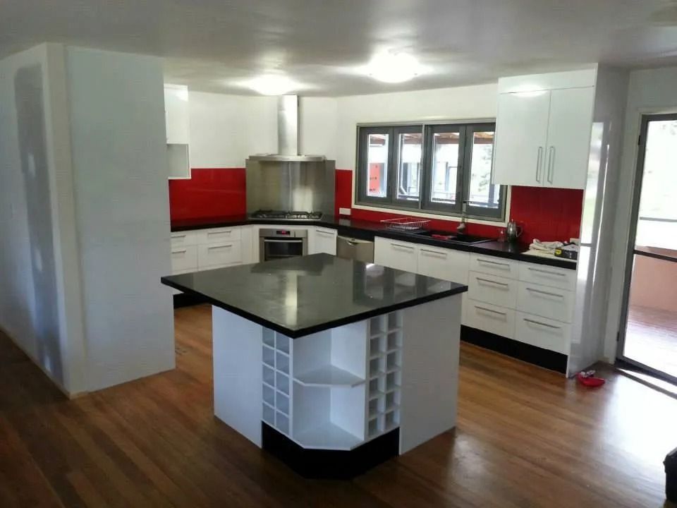 A Kitchen With White Cabinets and Black Counter Tops — Suncoast Kitchens In Kunda Park, QLD
