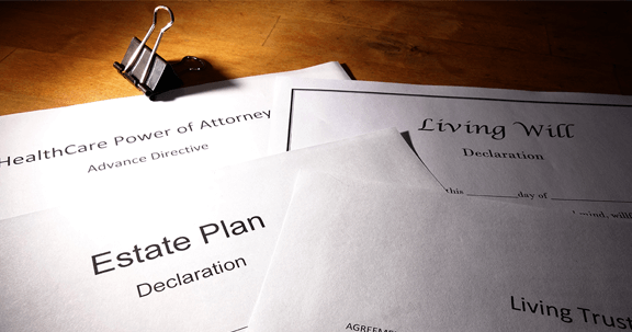 A stack of papers including an estate plan and a living will
