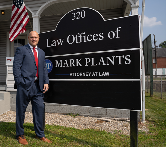 Mark Plants standing in front of his business office.