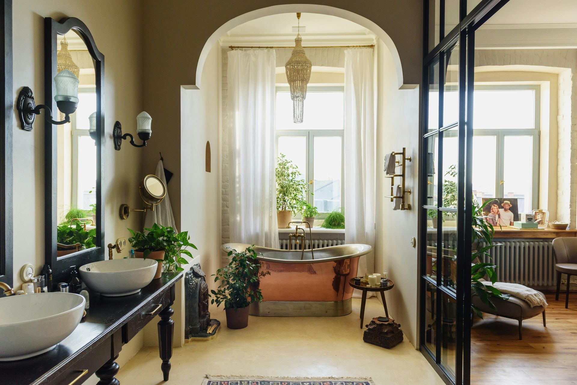 A bathroom with two sinks , two mirrors , a tub and a window.