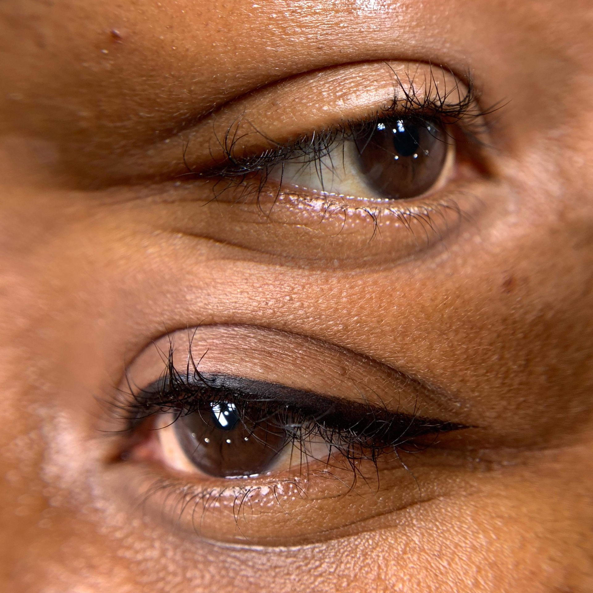 A close up of a woman 's eye with eyeliner on it.