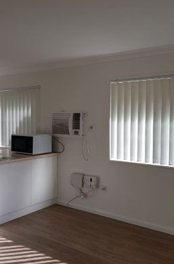 Room With Air Conditioner and Window With Blinds — Abundance Blinds In Budgewoi, NSW
