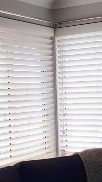 White Window Blinds Cover a Corner Window — Abundance Blinds In Wyong, NSW