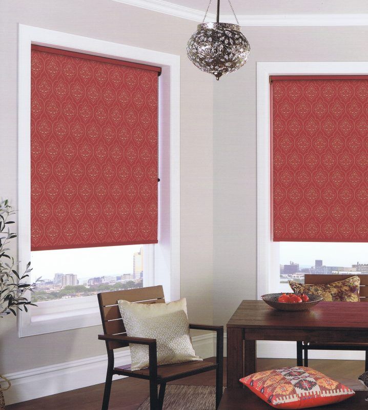 Two Red Patterned Roller Blinds in a Room — Abundance Blinds In Charmhaven, NSW