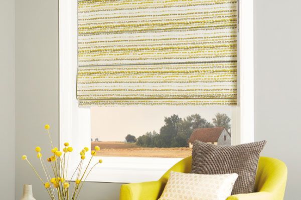 Yellow Chair With Pillows by Window With Patterned Blinds — Abundance Blinds In Charmhaven, NSW