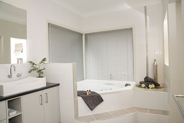Bathroom With a White Tub, Sink, and Blinds — Abundance Blinds In Charmhaven, NSW