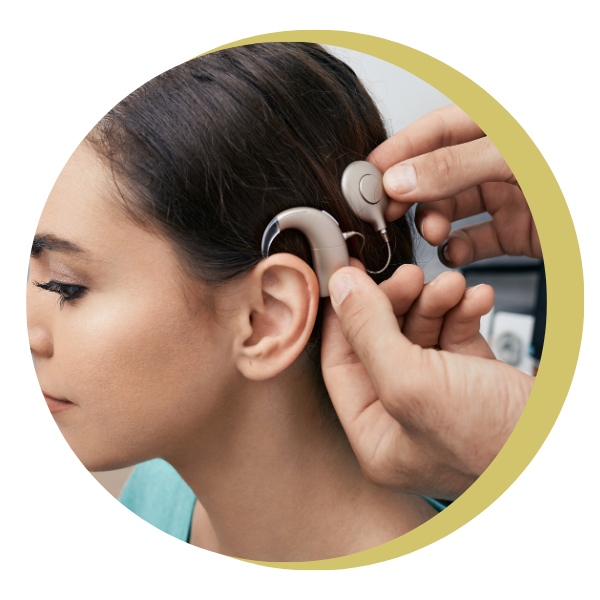 A person is putting a hearing aid in a woman 's ear