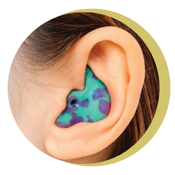 A close up of a person 's ear with a blue and purple ear plug