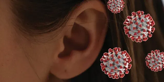 A close up of a woman 's ear with a virus coming out of it.