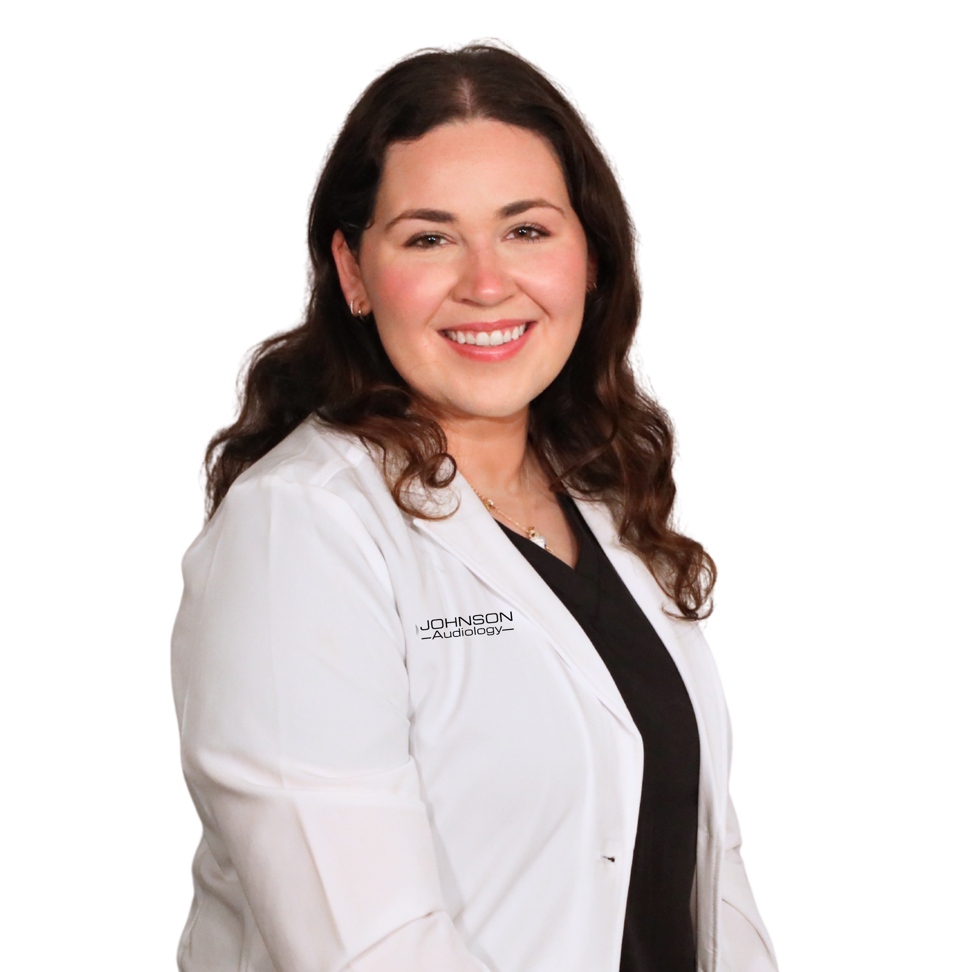 Woman in white lab coat smiling, dark hair, black top.