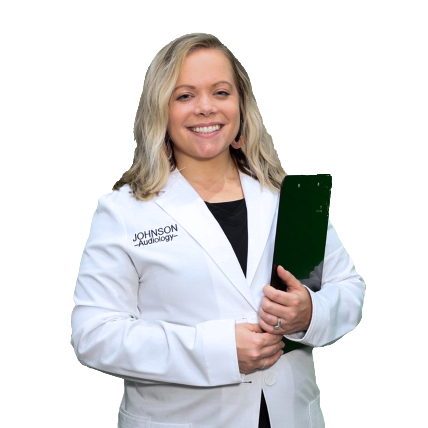 A woman in a white lab coat is smiling and holding a clipboard.
