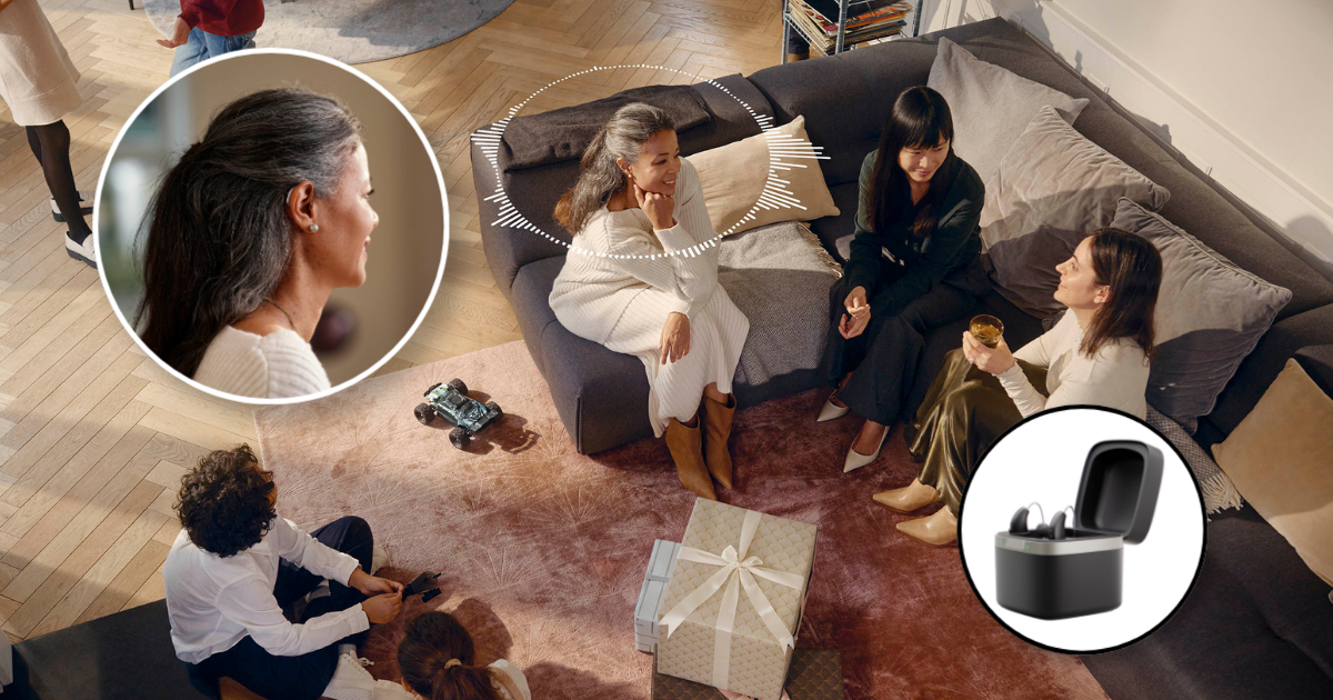 Person showing phone with urn image; another person looks on. Sunlight streams in.