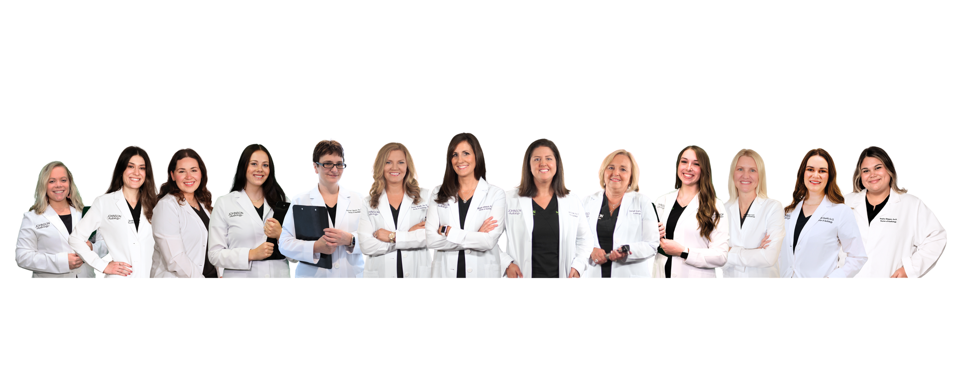 A group of doctors are standing in a row with their arms crossed.
