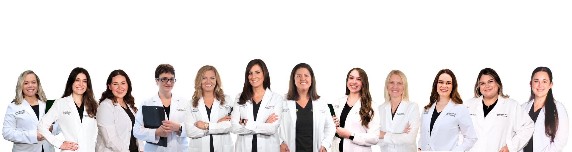 A group of doctors are standing in a row with their arms crossed.