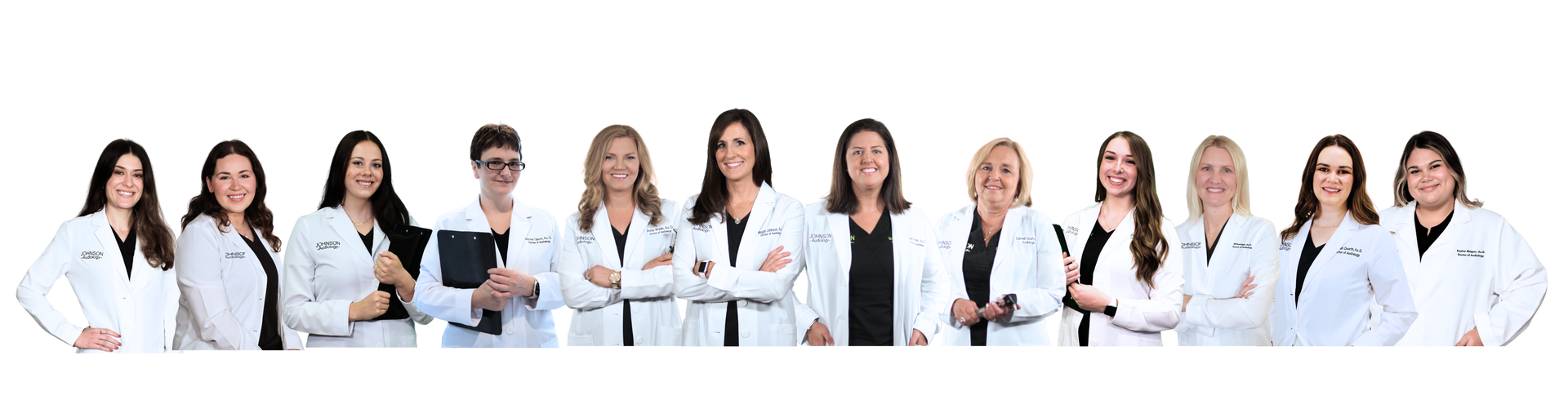 A group of doctors are standing in a row with their arms crossed.