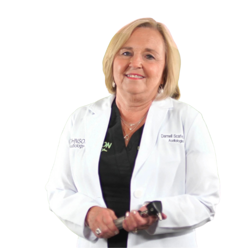 A woman in a white lab coat is smiling and holding a pair of keys.