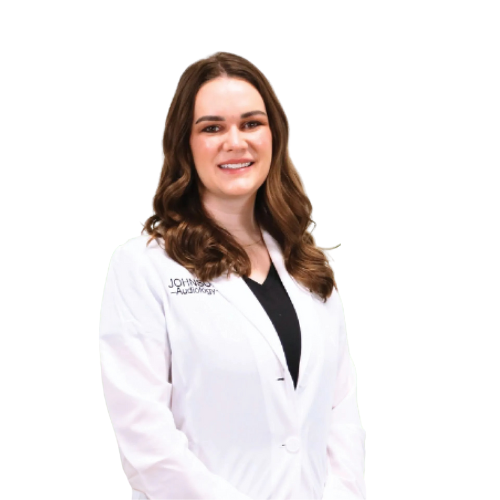 A woman in a white lab coat is smiling for the camera.