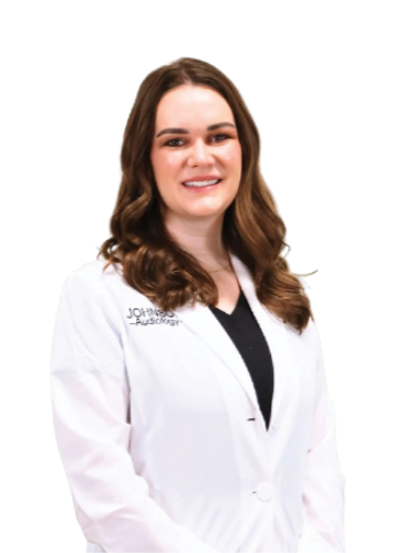 A woman in a white lab coat is smiling for the camera.