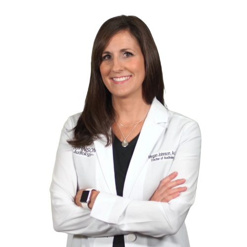 A woman in a lab coat is smiling with her arms crossed