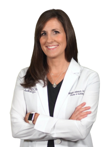 A woman in a lab coat is smiling with her arms crossed