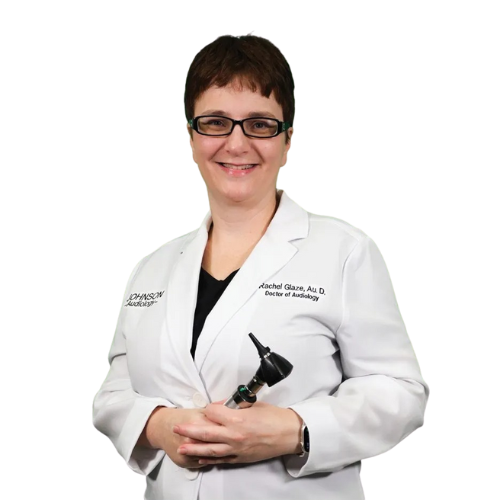 A woman in a lab coat is holding an ear scope