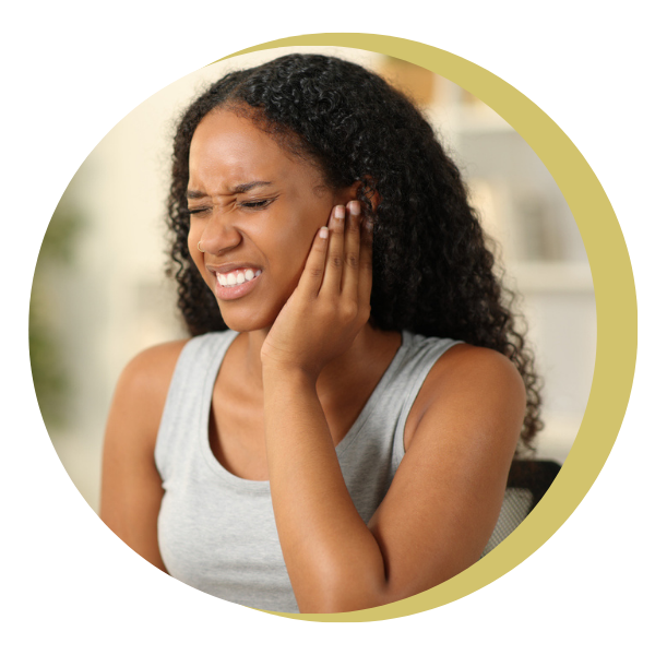 A woman is holding her ear because she has a toothache.