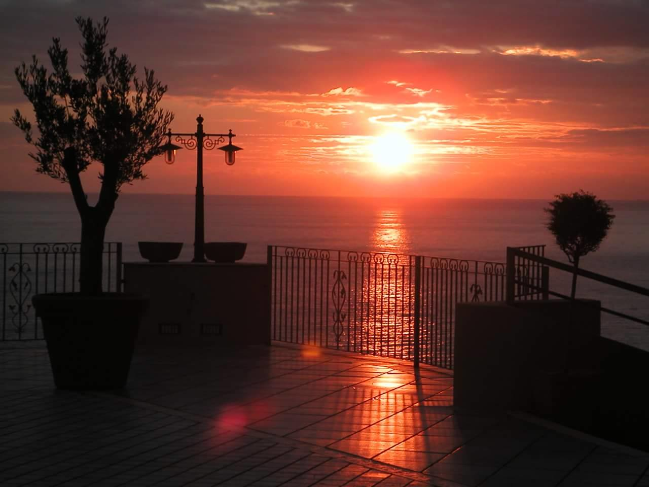 Il sole sta tramontando su uno specchio d'acqua