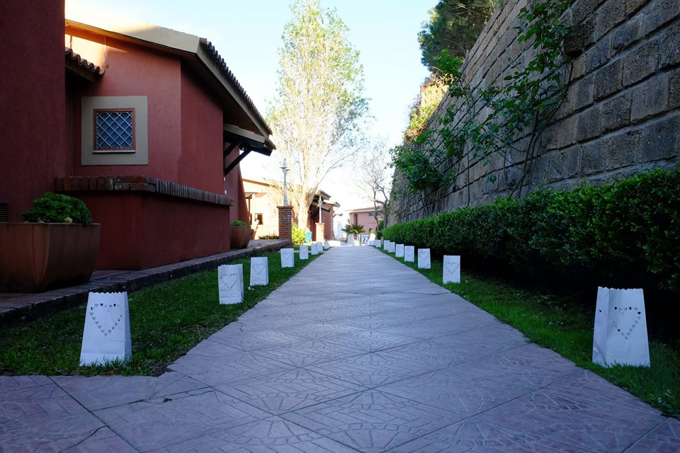 Una fila di sacchetti bianchi con dei cuori sopra sono allineati su un marciapiede