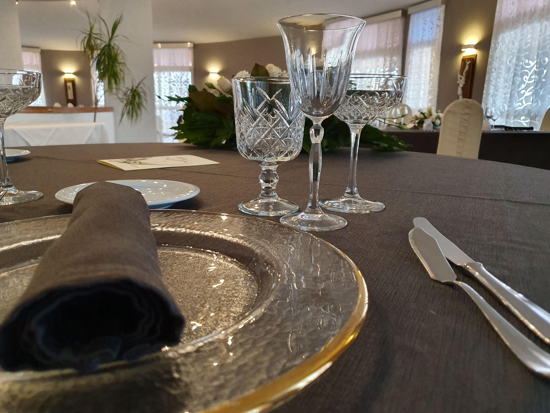 Un'apparecchiatura con piatti, bicchieri e posate su un tavolo