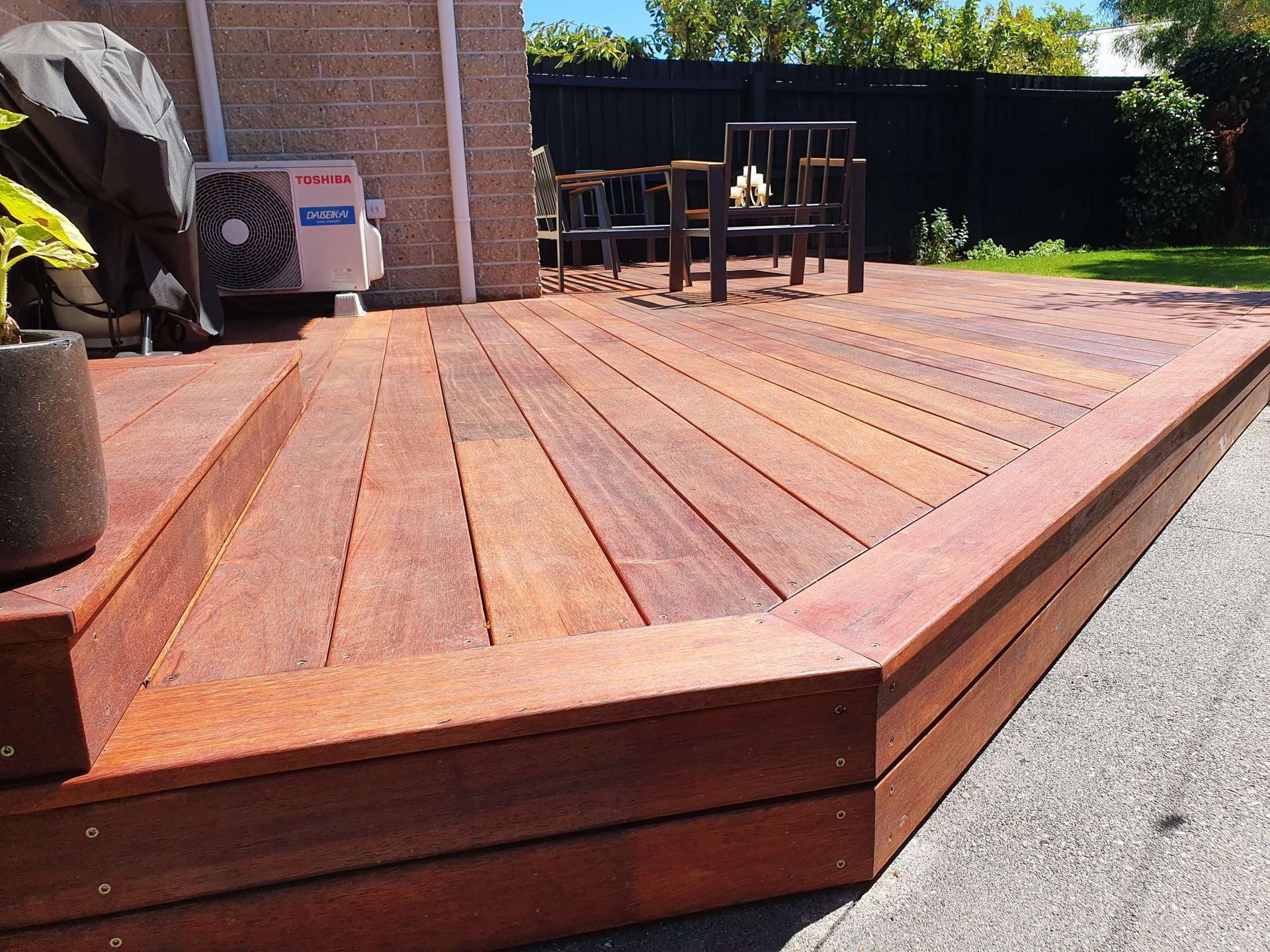 A wooden deck with stairs leading up to it