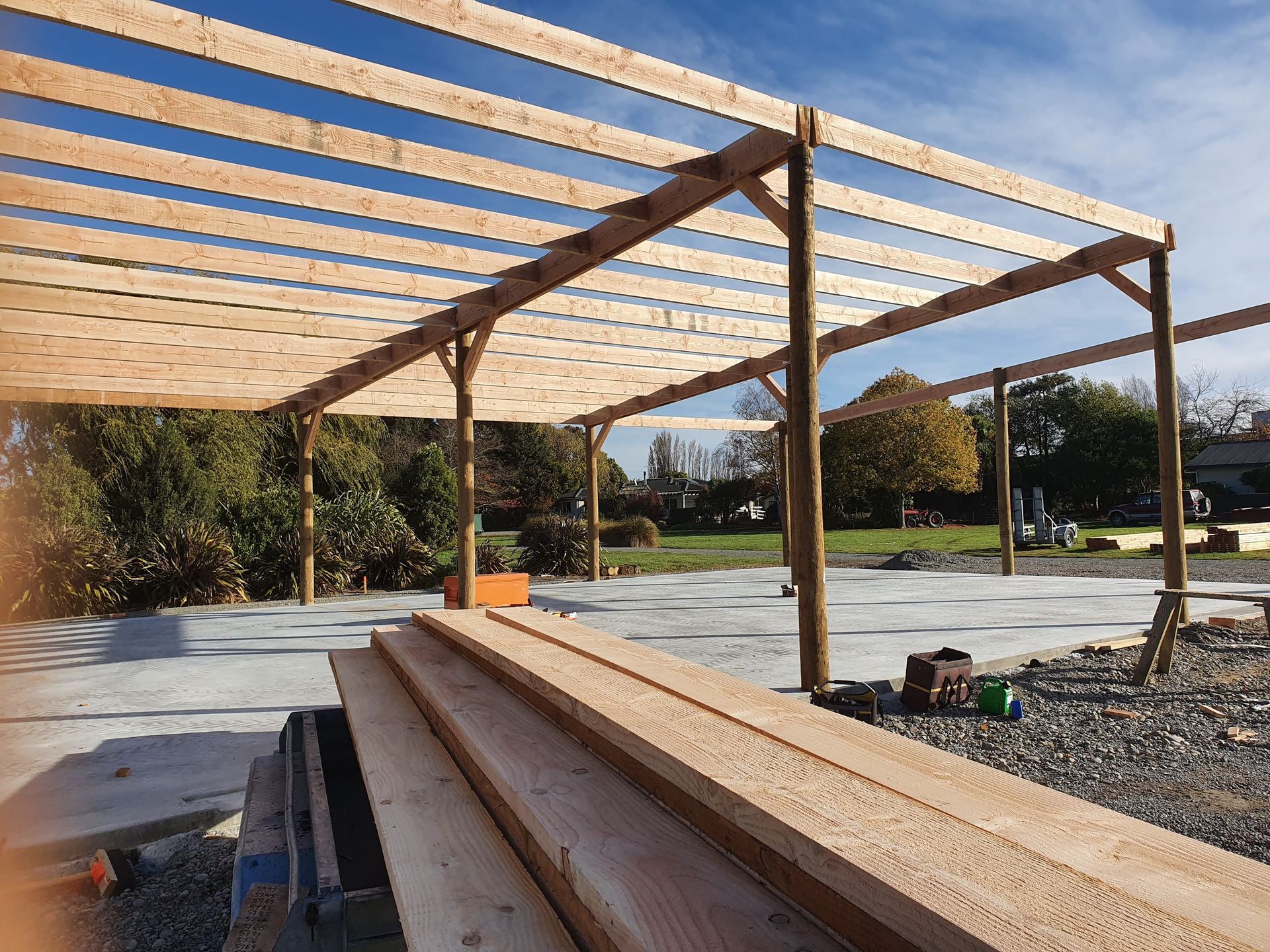 A stack of wooden beams sitting on top of a concrete floor.