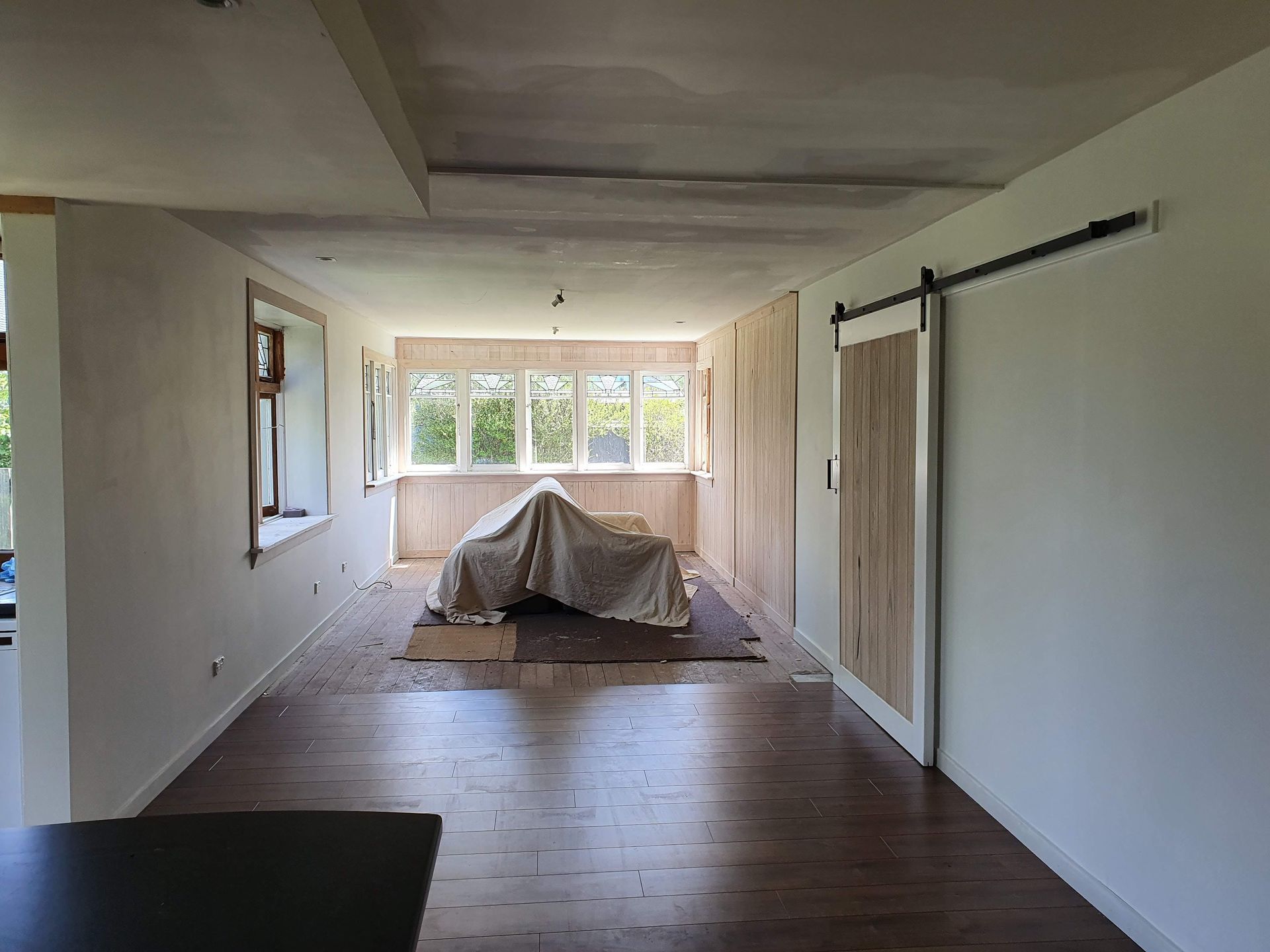 There is a sliding barn door in the middle of the room.