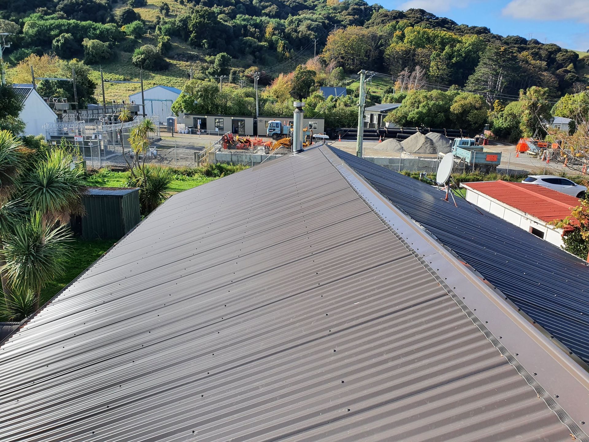 The roof of a house is covered in a corrugated metal roof.