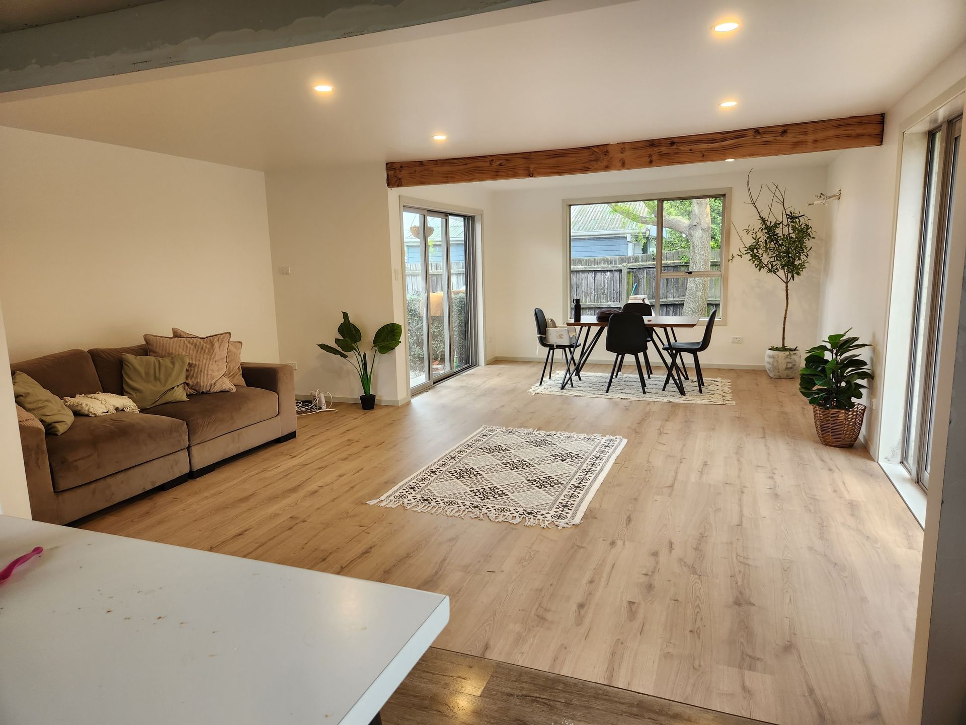 A living room with a couch , table and chairs.